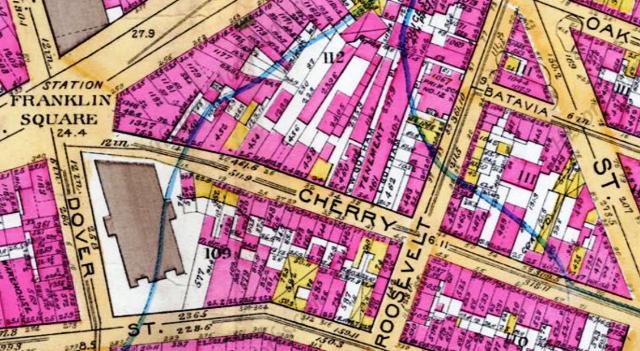 An 1891 atlas shows the vacant lot at 40 Cherry Street next to the massive Gotham Court tenement building.